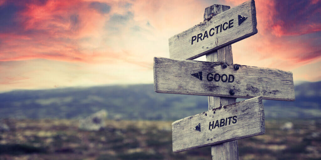 practice good habits text quote on wooden signpost outdoors in nature