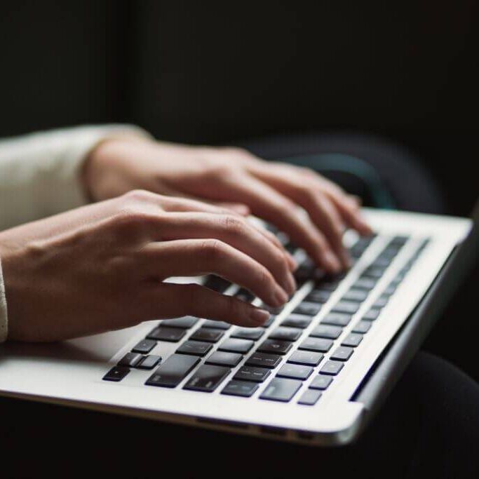 nsplsh_765a4a64596c354a565859~mv2 hands typing on a laptop keyboard