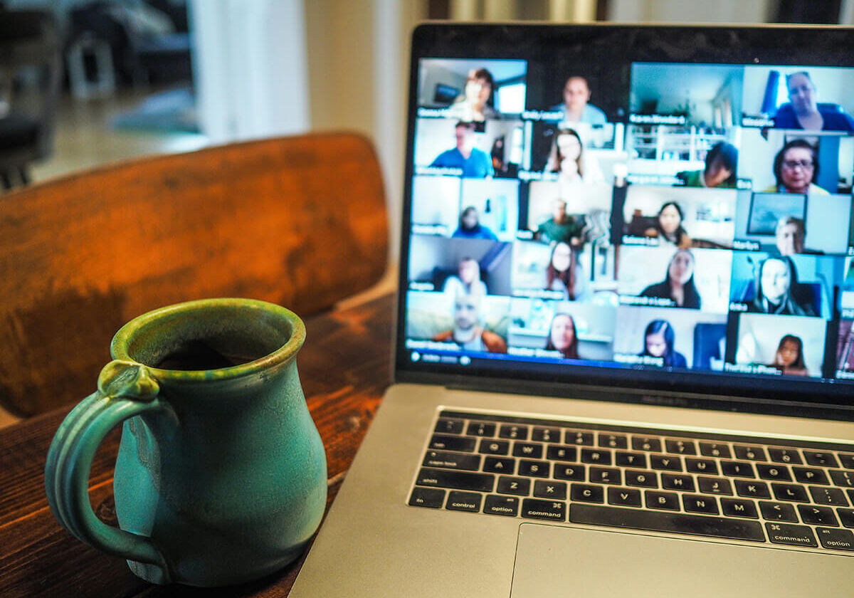 stock-meeting-4 zoom meeting on a laptop with mug next to it