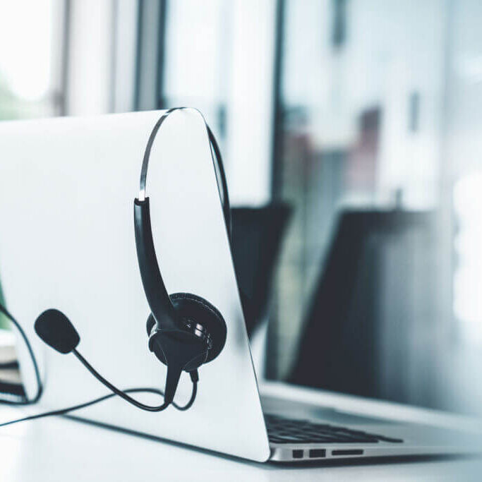 Headset and customer support equipment at call center ready for actively service . Corporate business help desk and telephone assistance concept .